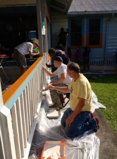 Rotary Club of Hilo members painting the preschool center at the YWCA of Hawaii Island.